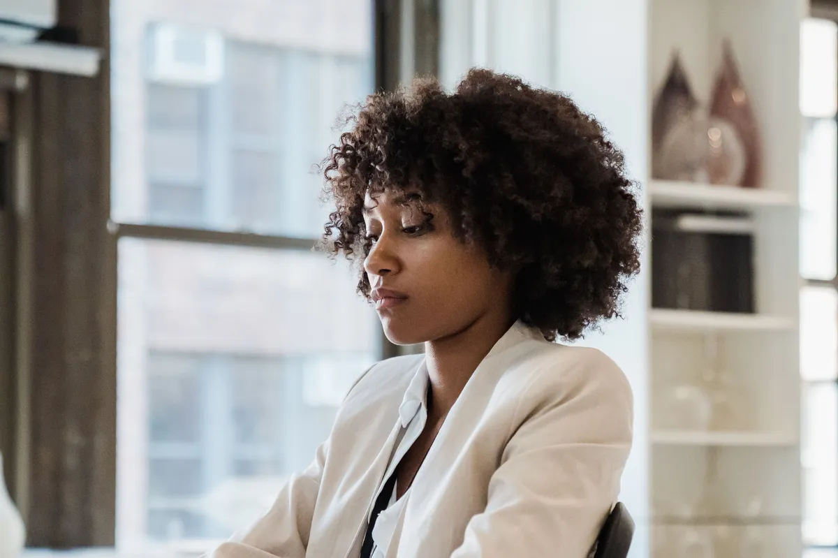 A product manager working at her desk in a sunlit office